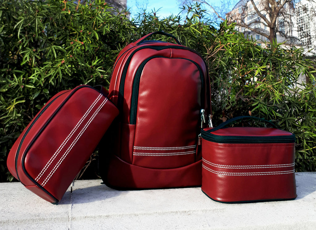 Cricket Red Messenger Bag Next To Toiletry Bag & Lunch Box