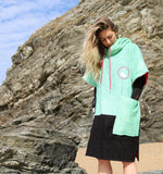Wave Style Poncho DOS Female Model Hands in Pockets of Surf Poncho